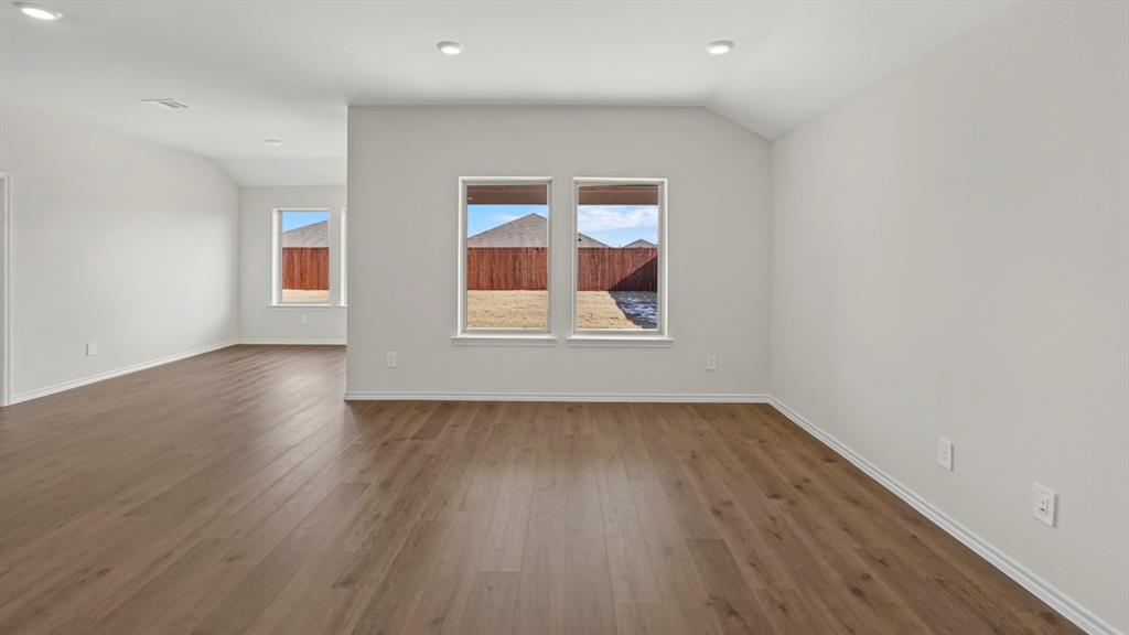 512 Yellow Rose Road Princeton, TX 75407 - Photo 32 of 37 an empty room with wooden floor and windows