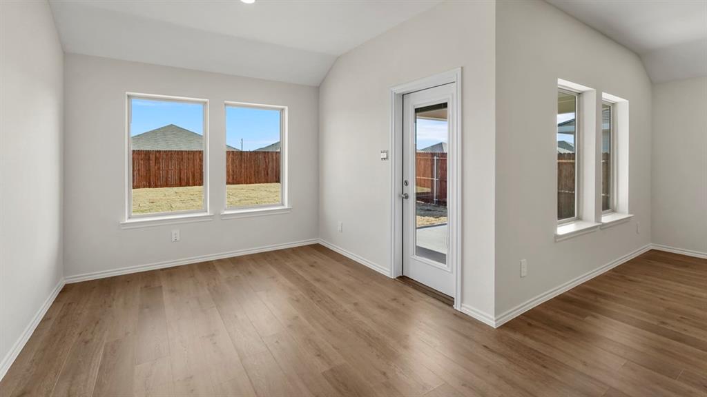 512 Yellow Rose Road Princeton, TX 75407 - Photo 33 of 37 a view of an empty room with wooden floor and a window