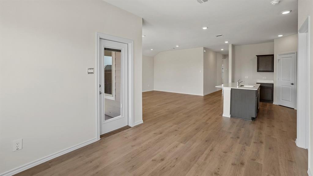 512 Yellow Rose Road Princeton, TX 75407 - Photo 34 of 37 an empty room with wooden floor and windows
