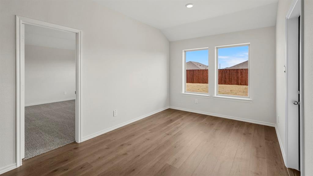 512 Yellow Rose Road Princeton, TX 75407 - Photo 37 of 37 a view of an empty room with wooden floor and windows