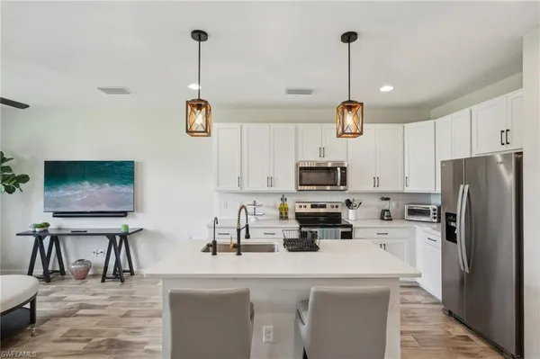 a kitchen with refrigerator and microwave