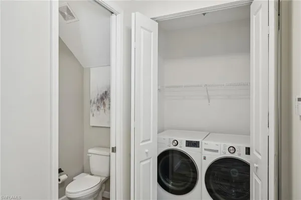 a view of bathroom with a washer and dryer