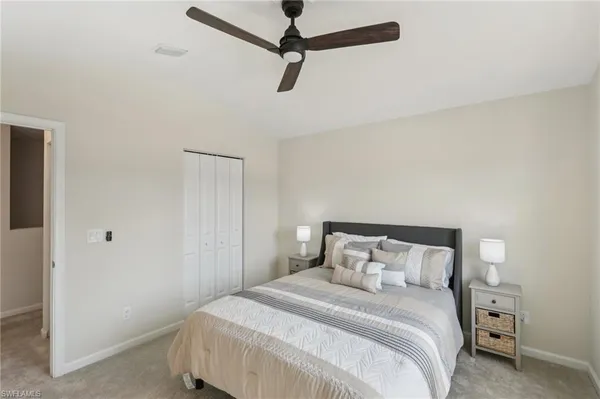 a bedroom with a bed and a ceiling fan