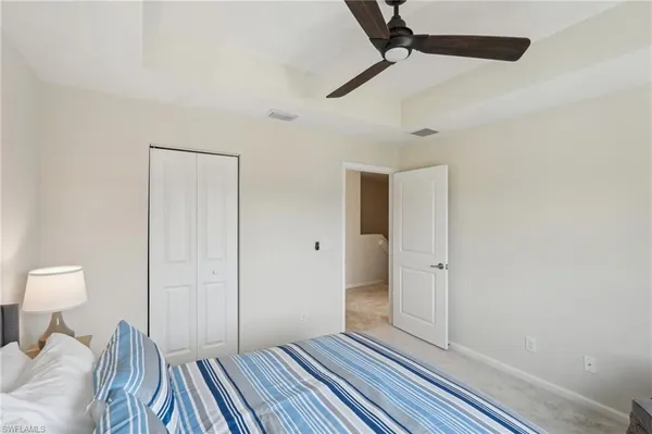 a view of a bedroom with wooden floor