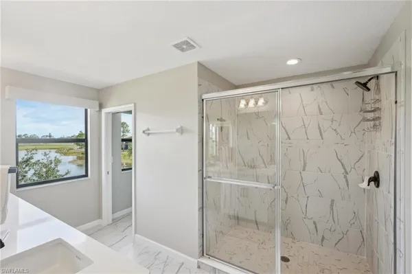 a bathroom with a shower and a mirror