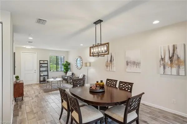 a view of a dining room with furniture wooden floor and chandelier