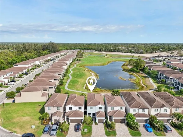 a view of a patio with table and chairs with wooden floor and fence