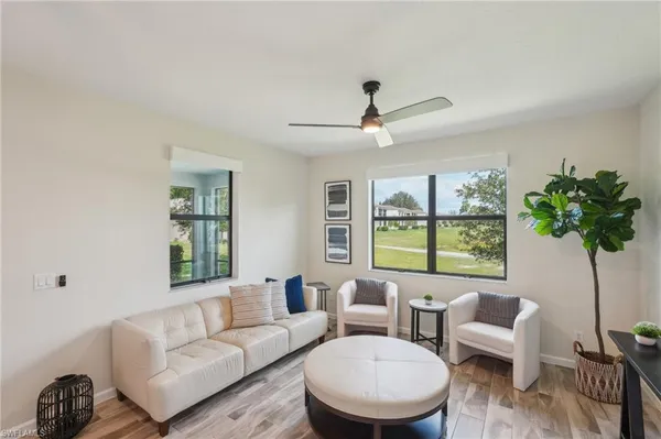 a living room with furniture and a large window