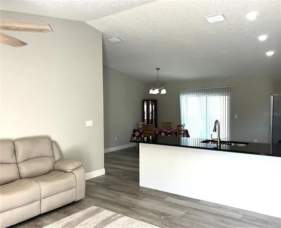 a living room with furniture and a large mirror