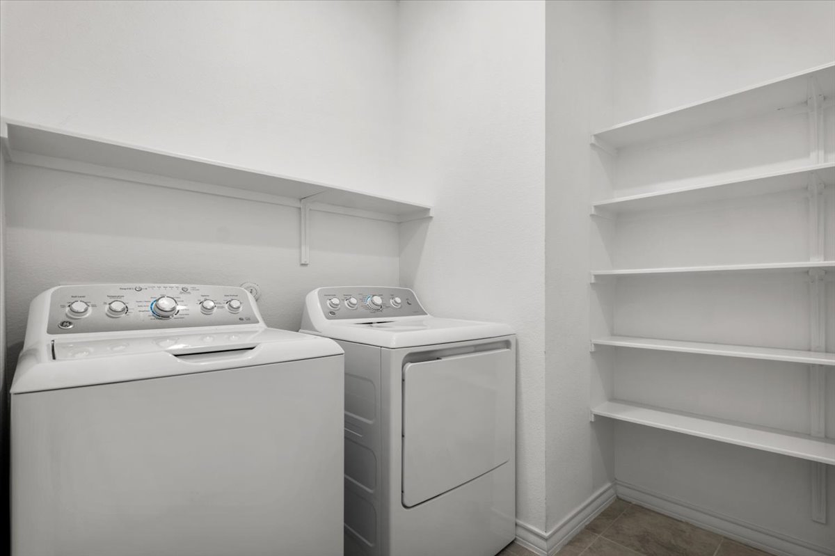 500 Stinchcomb Road Hutto, TX 78634 - Photo 24 of 37 Functional laundry room equipped with shelving for convenient storage.