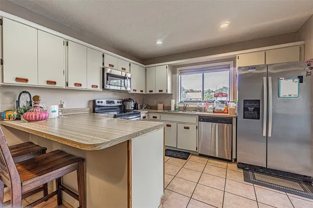 a kitchen with stainless steel appliances granite countertop a refrigerator sink and cabinets