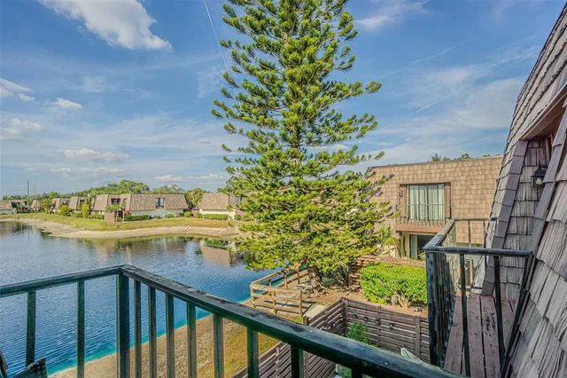 a view of a balcony with wooden floor and fence