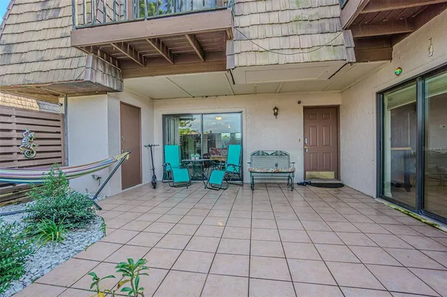 a view of a patio with table and chairs and potted plants