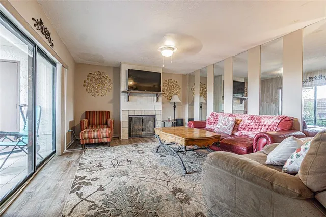a living room with furniture a fireplace and a flat screen tv