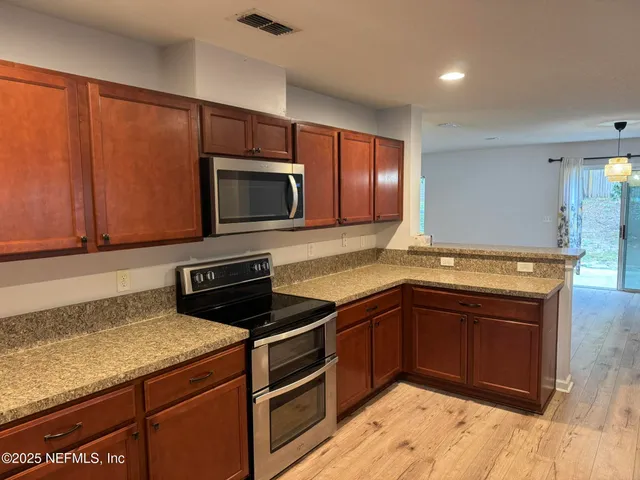 a view of living room filled with furniture and wooden floor