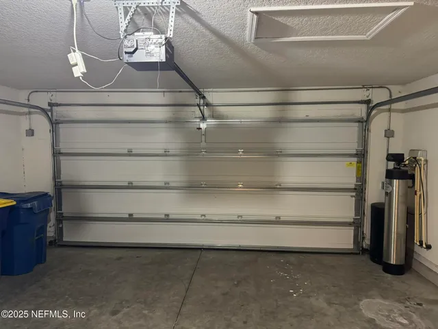 an empty room with wooden floor and mirror