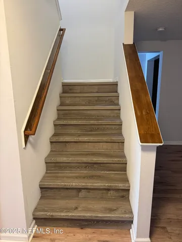 a view of an empty room with window and closet area