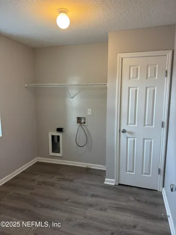 a bathroom with a granite countertop toilet and a sink