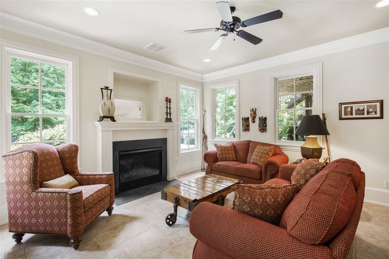 1512 Consett Court Raleigh, NC 27613 - Photo 24 of 30 Basement family room with gas log fireplace and French door to coverd patio with fire pit Basement family room