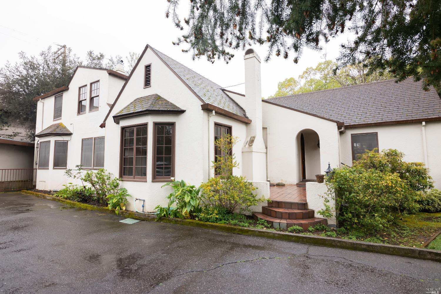 a front view of a house with a yard and a garage