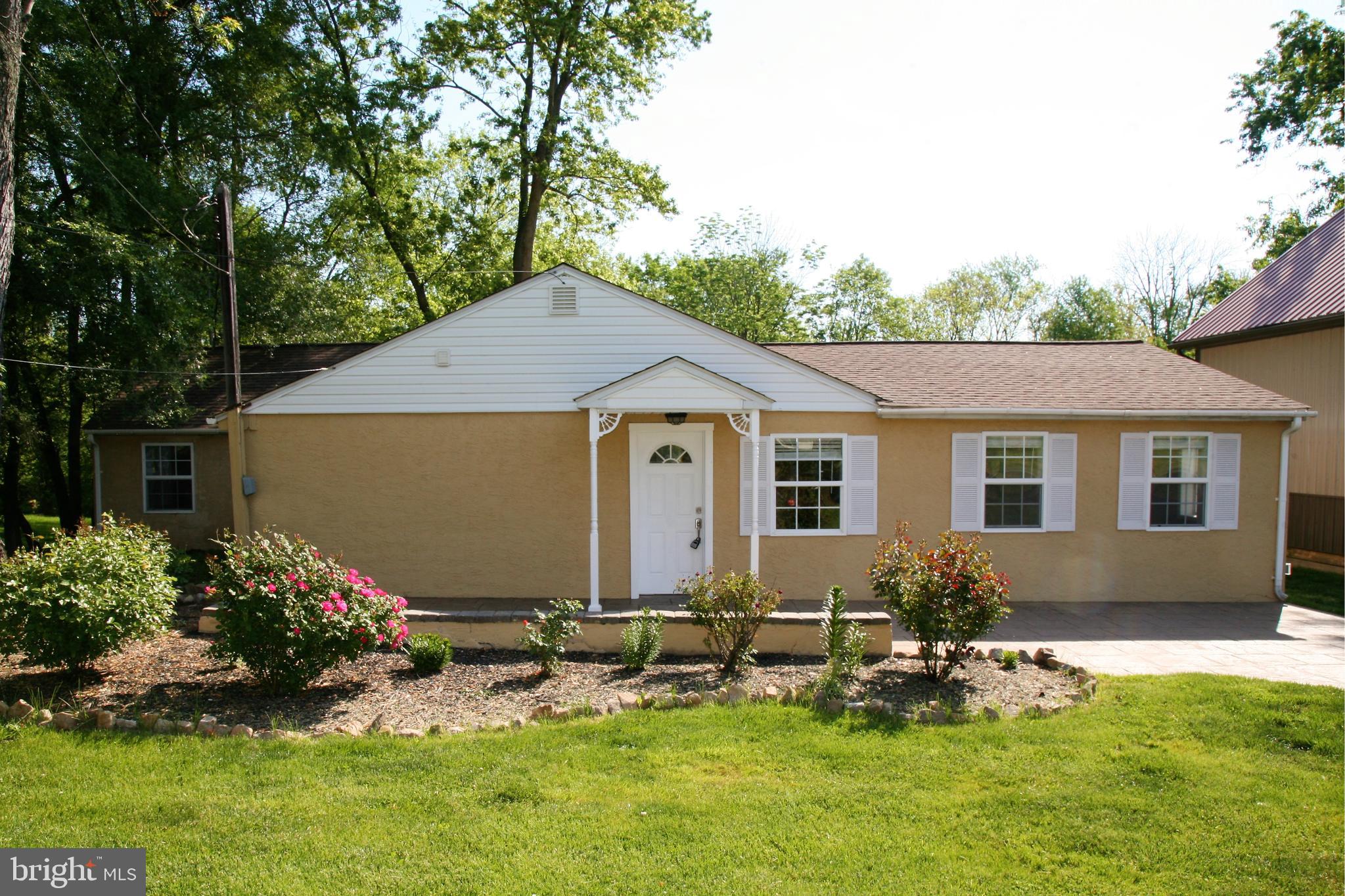 a front view of house with yard and outdoor seating