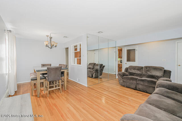122 Retford Avenue Staten Island, NY 10312 - Photo 11 of 29 a living room with furniture and a wooden floor