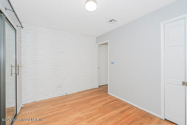 122 Retford Avenue Staten Island, NY 10312 - Photo 22 of 29 a view of empty room with wooden floor