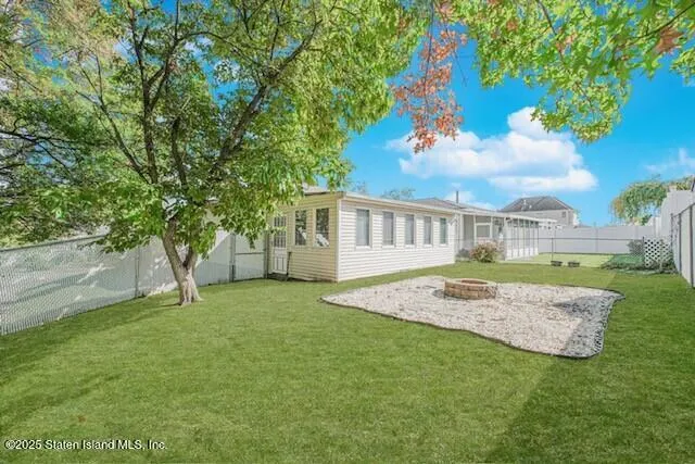 a view of house with backyard and garden