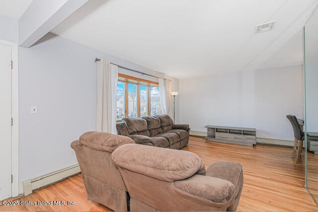 122 Retford Avenue Staten Island, NY 10312 - Photo 8 of 29 a living room with furniture and a wooden floor