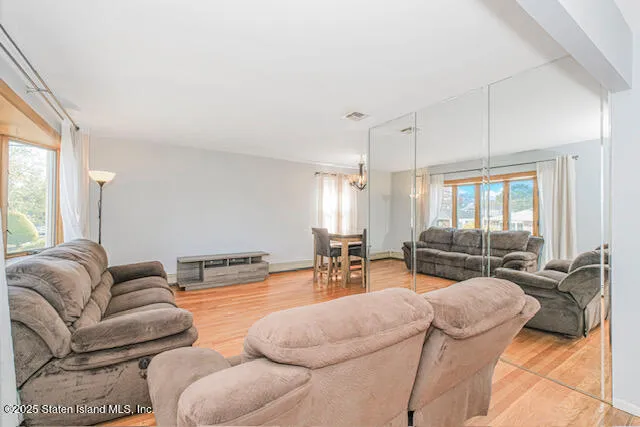 a living room with furniture window and wooden floor