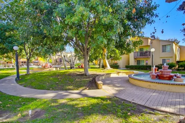 a view of a house with swimming pool and sitting area
