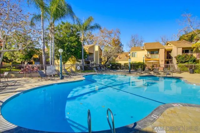 a view of a swimming pool with outdoor seating