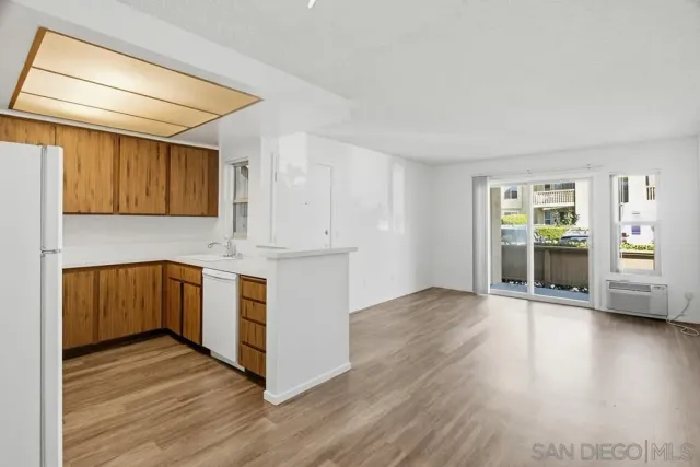 a kitchen with wooden floors and wooden cabinets