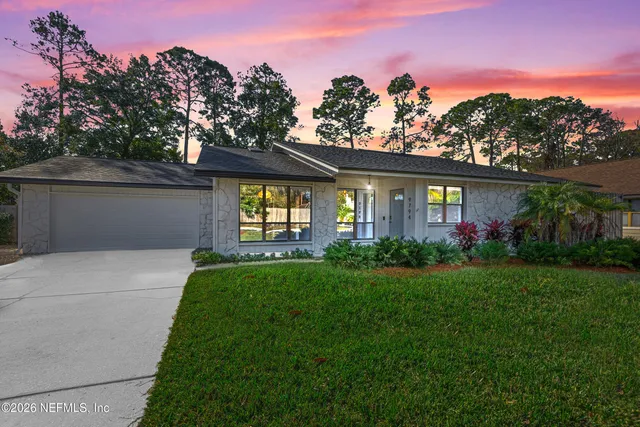 a front view of a house with a garden