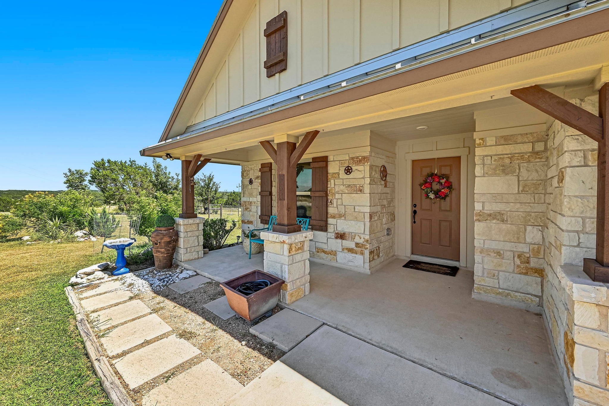 560 Saddle Ridge Drive Bertram, TX 78605 - Photo 3 of 27 a view of a patio with table and chairs and potted plants