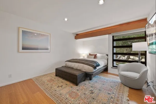 a bedroom with a large bed and a large window