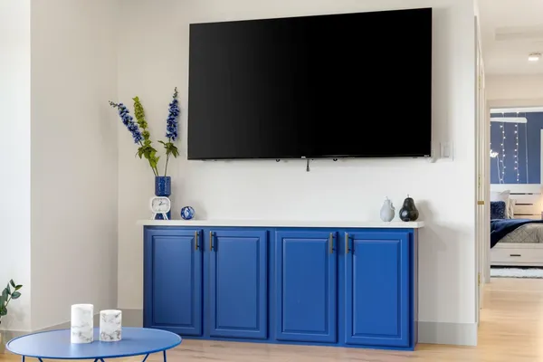 a bedroom with a bed and a television