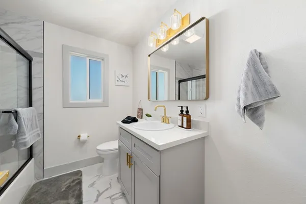 a view of a kitchen with a sink and a refrigerator