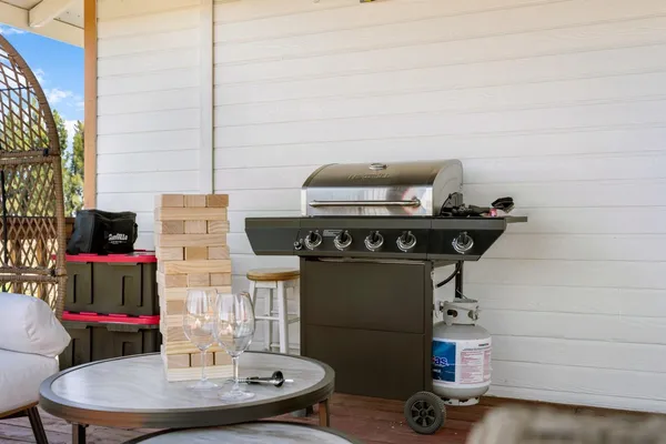 a view of a house with a big yard potted plants and large tree