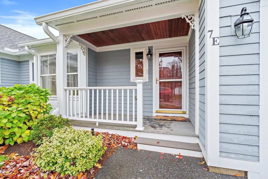 7 E Strawberry Lane, Unit E Hudson, MA 01749 - Photo 1 of 38 a front view of a house with a flower plants