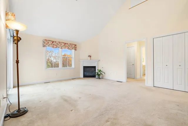 a view of an empty room with a fireplace