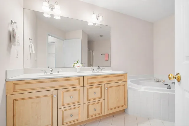 a bathroom with a sink a vanity and a large mirror