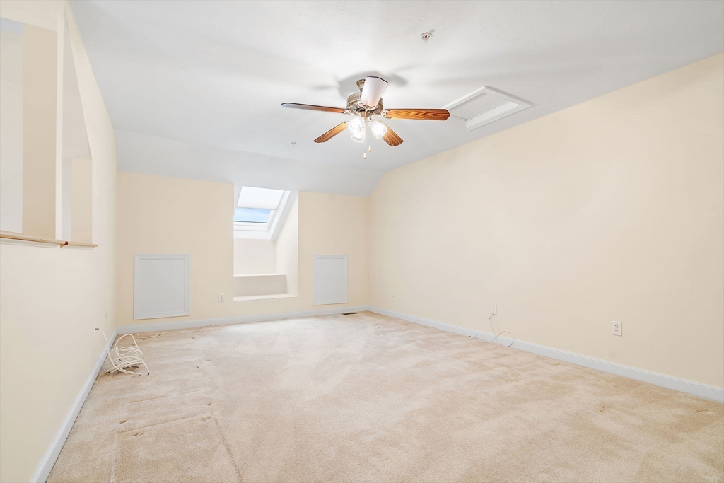 7 E Strawberry Lane, Unit E Hudson, MA 01749 - Photo 27 of 38 an empty room with windows and fan
