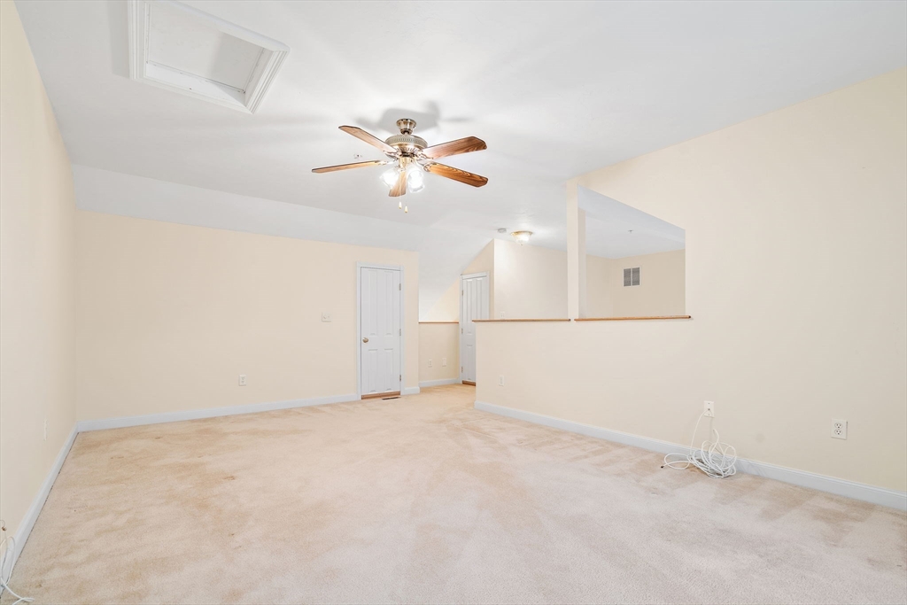 7 E Strawberry Lane, Unit E Hudson, MA 01749 - Photo 28 of 38 an empty room with chandelier fan and ceiling fan
