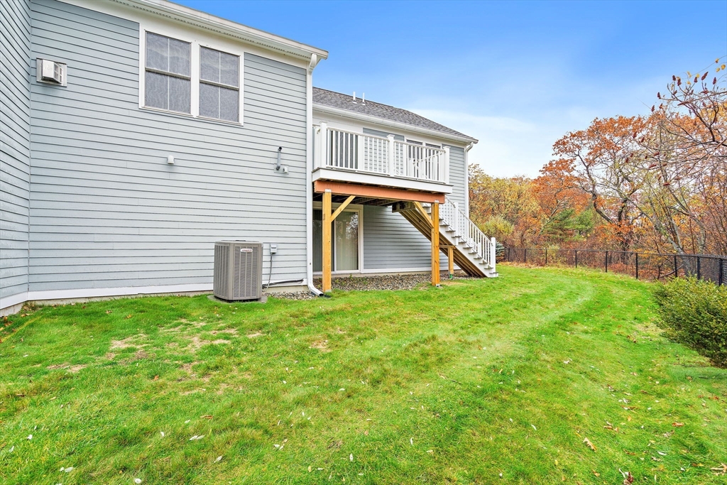 7 E Strawberry Lane, Unit E Hudson, MA 01749 - Photo 33 of 38 a view of a house with backyard and a tree