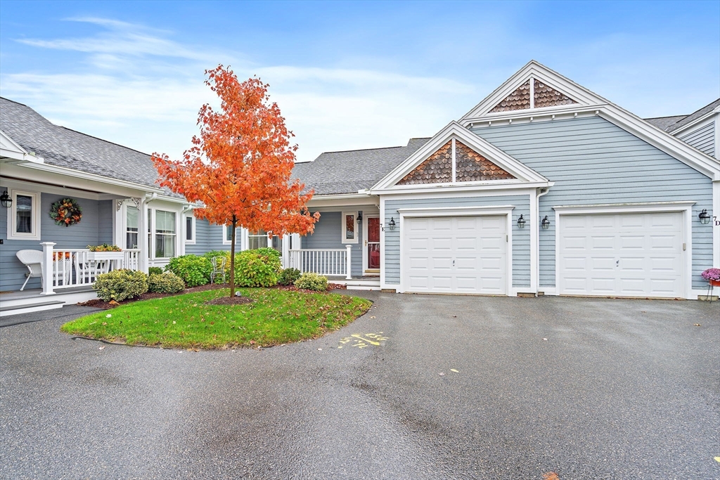 7 E Strawberry Lane, Unit E Hudson, MA 01749 - Photo 34 of 38 a front view of a house with a yard and garage