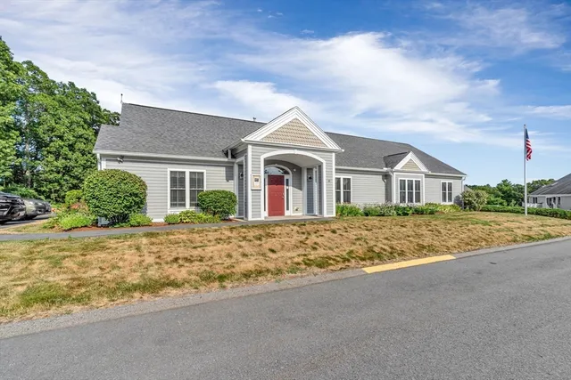 a living room with furniture a chandelier and a bookshelf