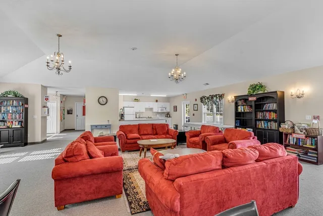 a view of a dining room with furniture and chandelier
