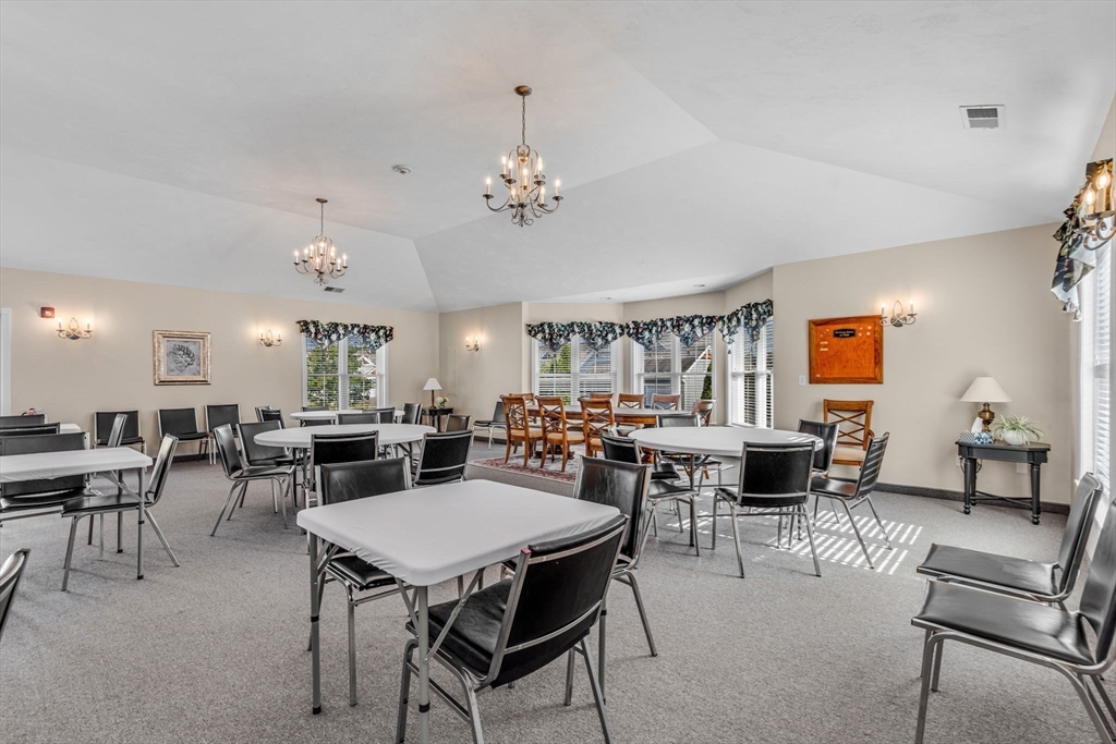 7 E Strawberry Lane, Unit E Hudson, MA 01749 - Photo 38 of 38 a view of a dining room with furniture and chandelier