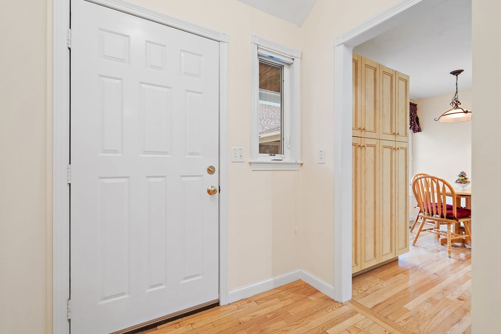 7 E Strawberry Lane, Unit E Hudson, MA 01749 - Photo 4 of 38 a view of a hallway with wooden floor and dining room